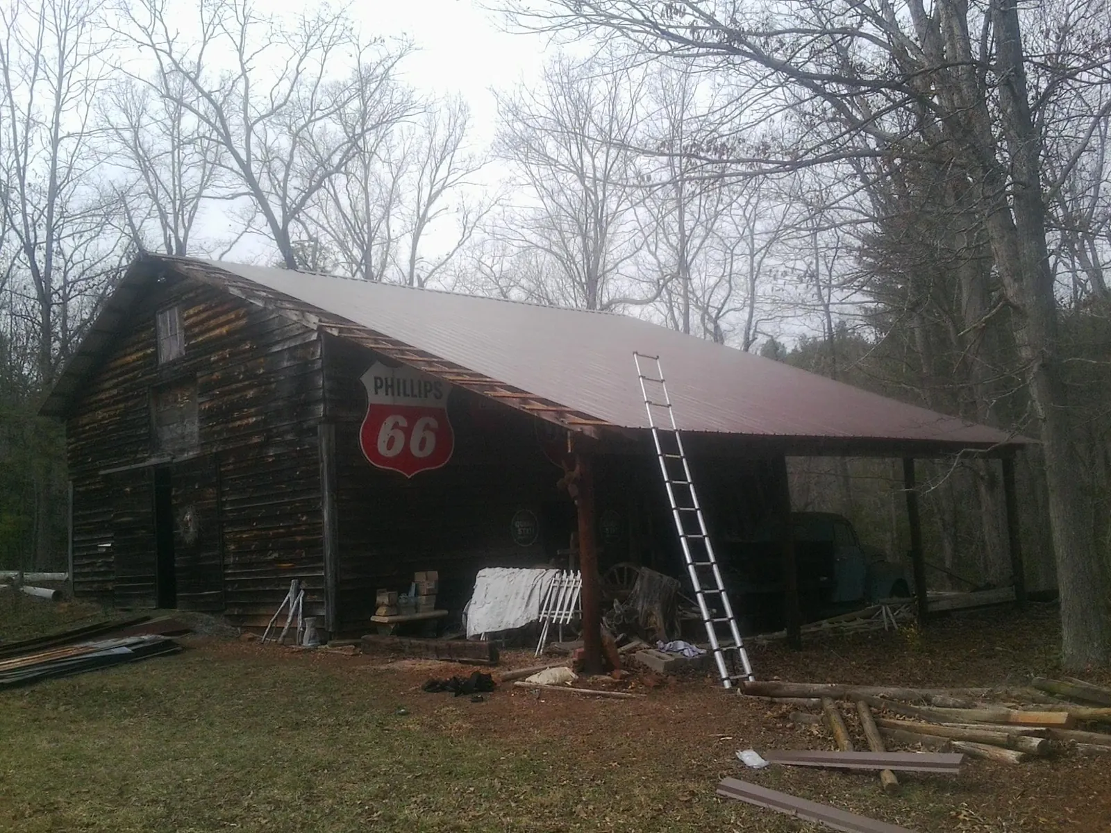New metal roof on an open sided timber barn with a vintage sign in Cassville